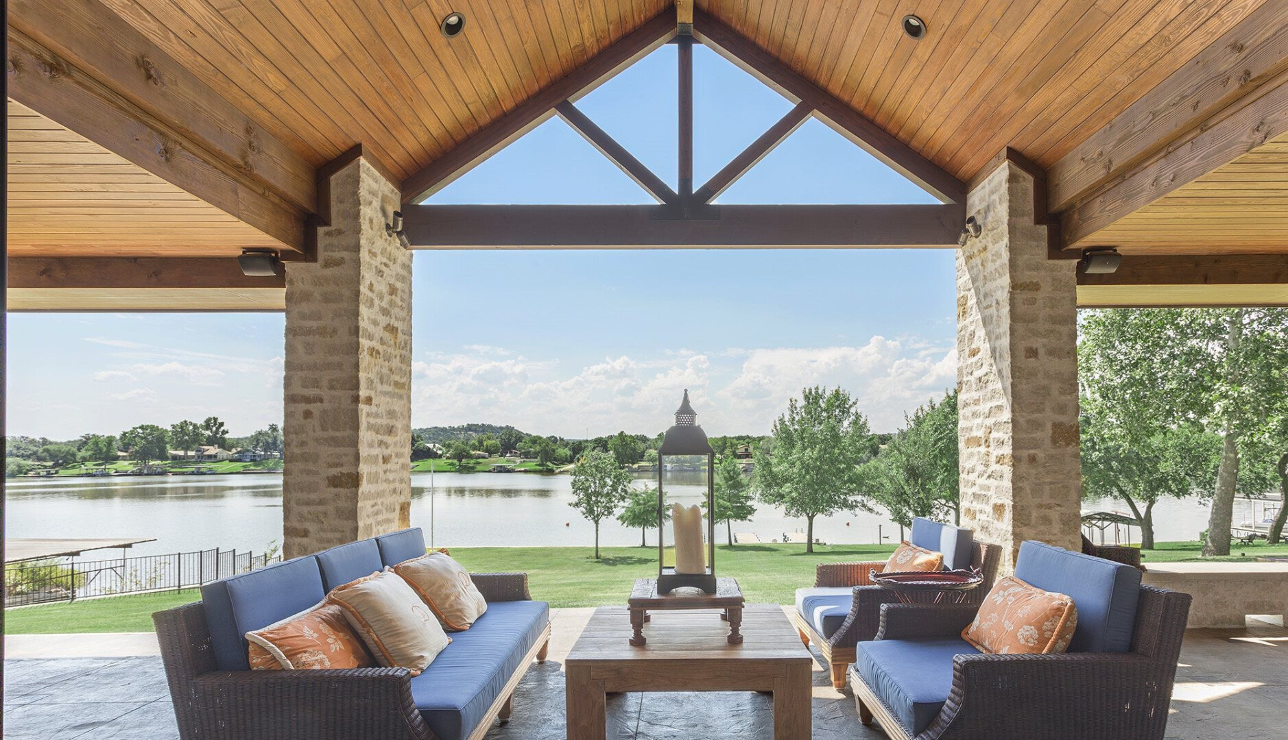 Rear view of lakefront home with a large back patio overlooking the water, Lake LBJ TX